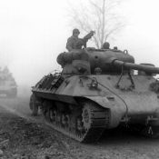 U.S soldiers driving tanks through the Belgium countryside