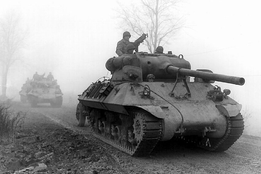 U.S soldiers driving tanks through the Belgium countryside