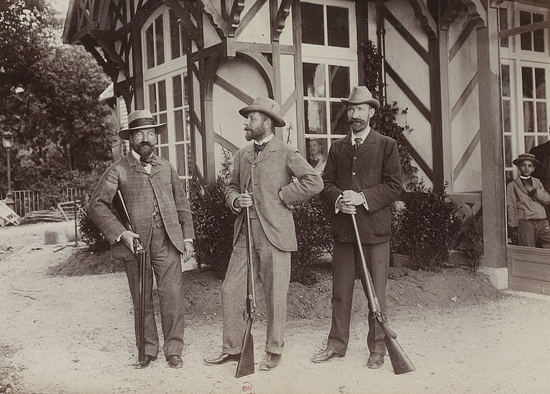 Athletes for Olympic live pigeon shooting pose with their rifles