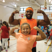 Darrion Crockwell flexes with one of his students during a PE class.