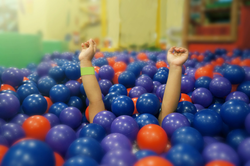 Child playing in ball pit