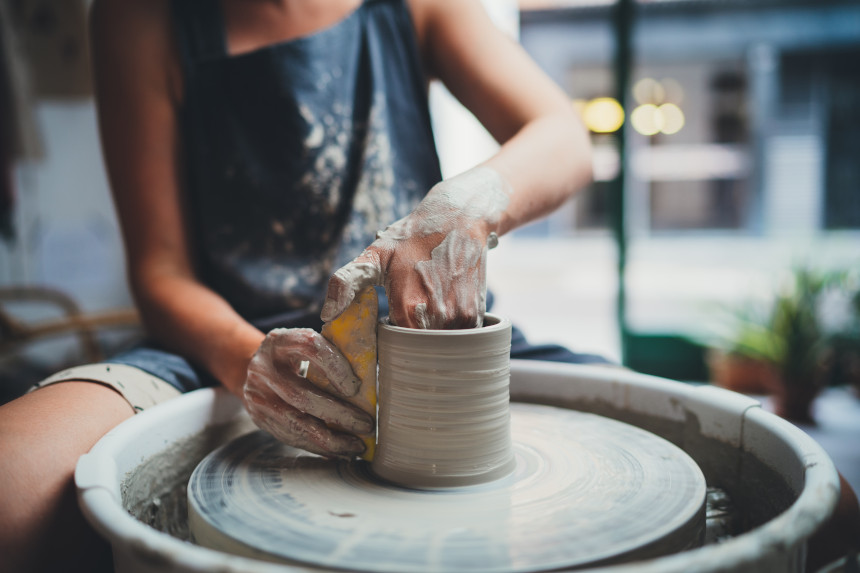 Ceramics artist using a pottery wheel
