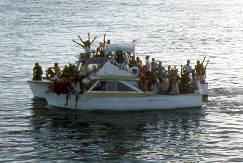 Cuban refugees on an overcrowded boat wave