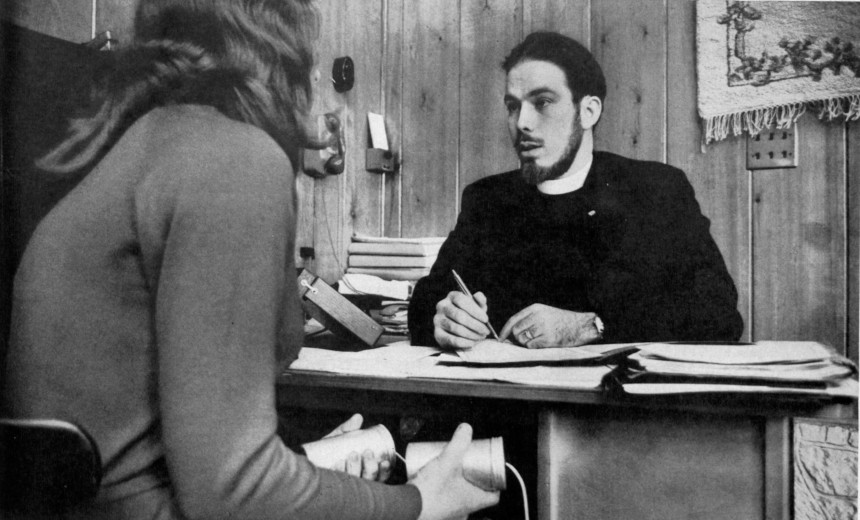 A student holds the infamous Scientology e-readers as she is being interviewed by one of their auditors.