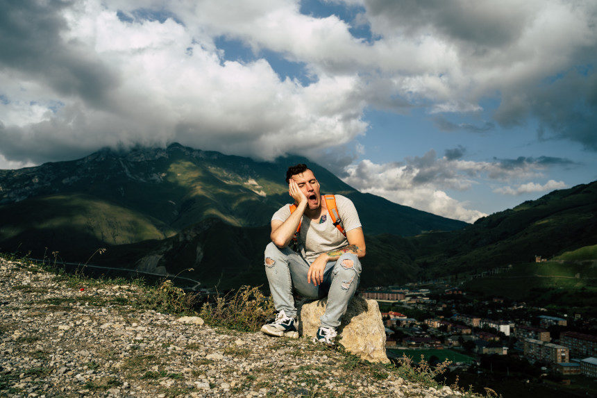 A tired mountain hiker takes a break.