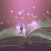 A small boy walks on the pages of a large, open book.