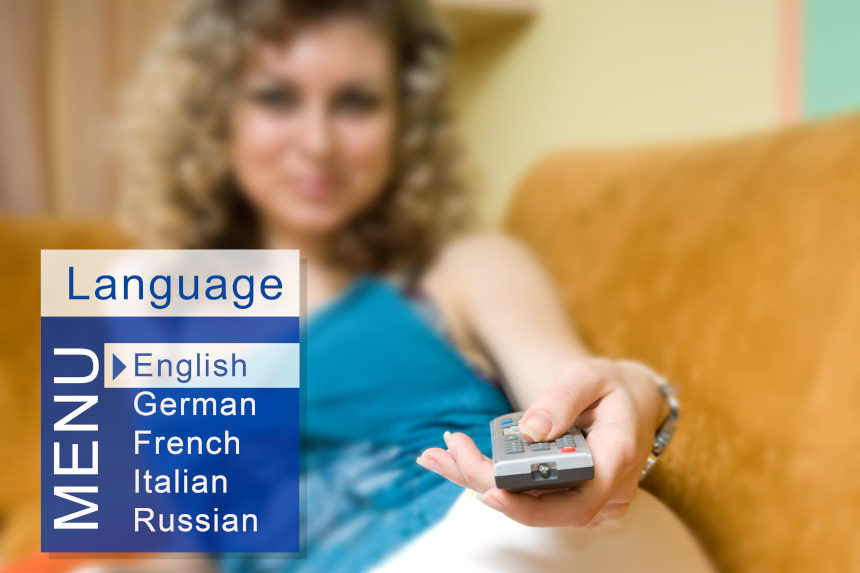 Young woman choosing the language for television subtitles