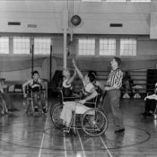 Disabled athletes in wheelchairs play a basketball game in the 1940s