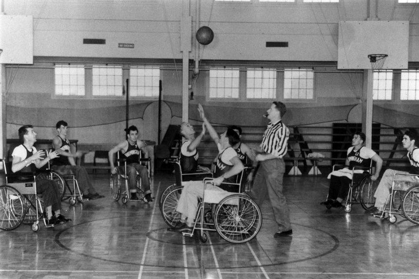 Disabled athletes in wheelchairs play a basketball game in the 1940s