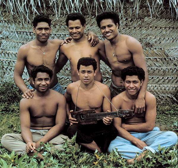 Kolo and other boys on the island pose with his makeshift guitar.