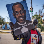 Marcus Arbery, Sr., father of Ahmaud Arbery, carries a portrait of his son in the Rev. Martin Luther King, Jr. Day Parade on January 18, 2021, in Brunswick, Georgia (Michael Scott Milner / Shutterstock)