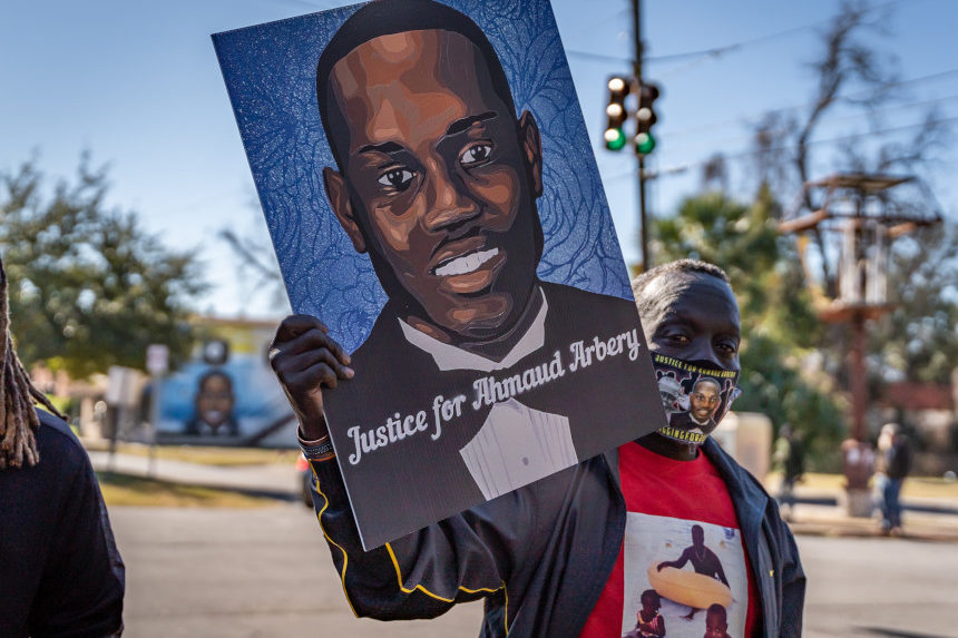 Marcus Arbery, Sr., father of Ahmaud Arbery, carries a portrait of his son in the Rev. Martin Luther King, Jr. Day Parade on January 18, 2021, in Brunswick, Georgia (Michael Scott Milner / Shutterstock)