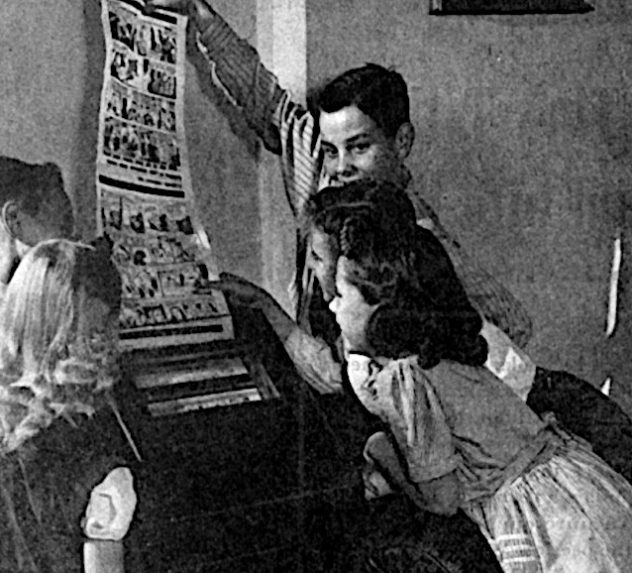 Kids pulling a newspaper from a fax machine