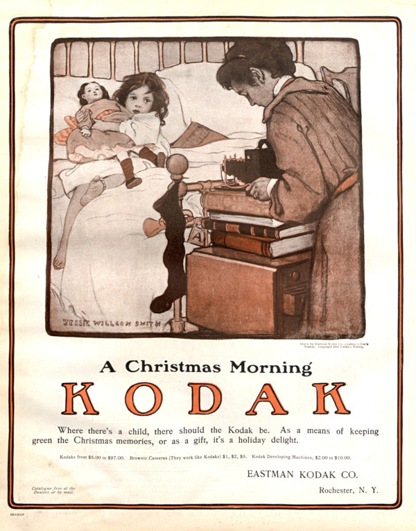Vintage Kodak ad showing a mother taking a photo of her child.