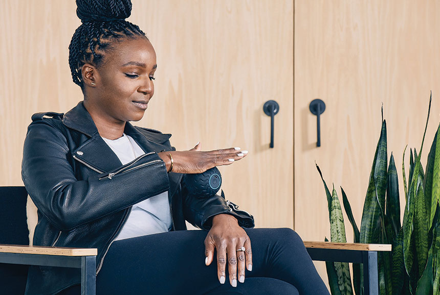 Woman using the Wave Solo personal massager on her wrists