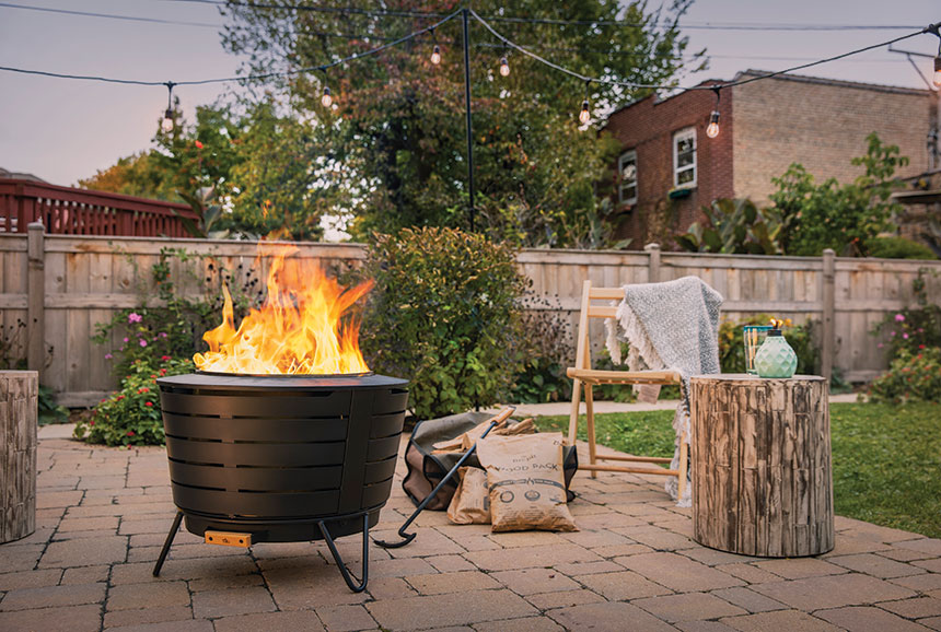 A Tiki Brand fire pit in a backyard