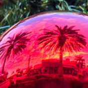 A Christmas ornament reflecting an image of a coastal town.