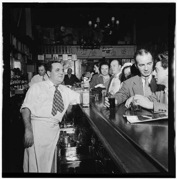 Men at a 1940s tavern all wear ties as they take their drinks.