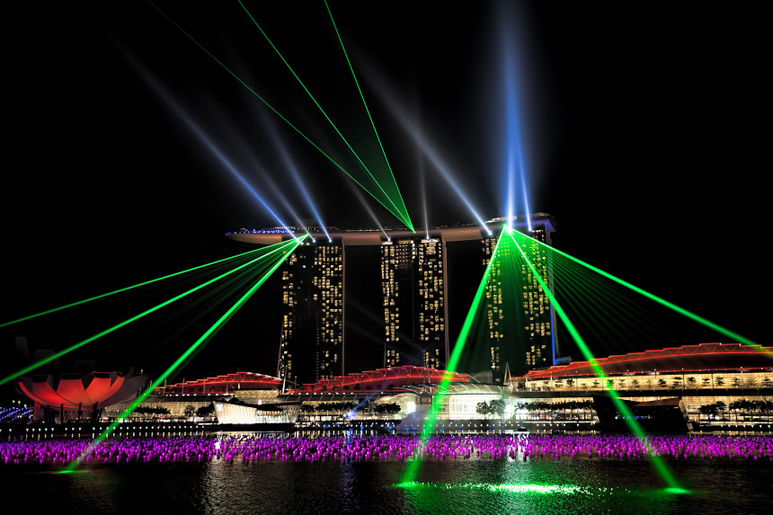 New Year's Eve celebration in Singapore, with lasers being reflected off the skyline.