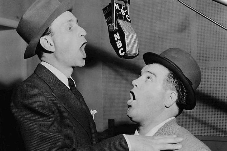 Bud Abbott and Lou Costello performing in a radio booth