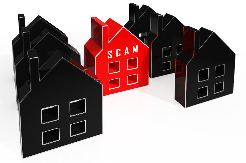 A home marked "scam" stands out among a group of houses.