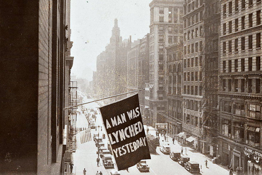 A flag outside the NAACP HQ in New York City that reads "A Man Was Lynched Yesterday"