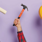 Men holding a paint roller, a hammer, and a hard hat.