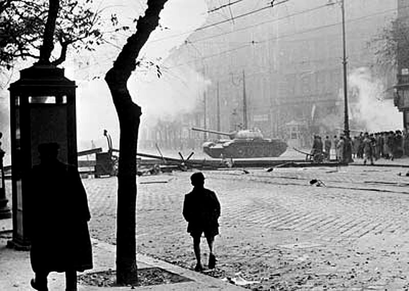 Child watches a Soviet tank drive through Budapest in 1956