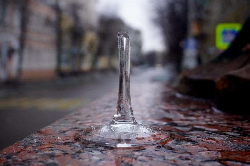 a rain drop hitting a puddle and causing a ripple