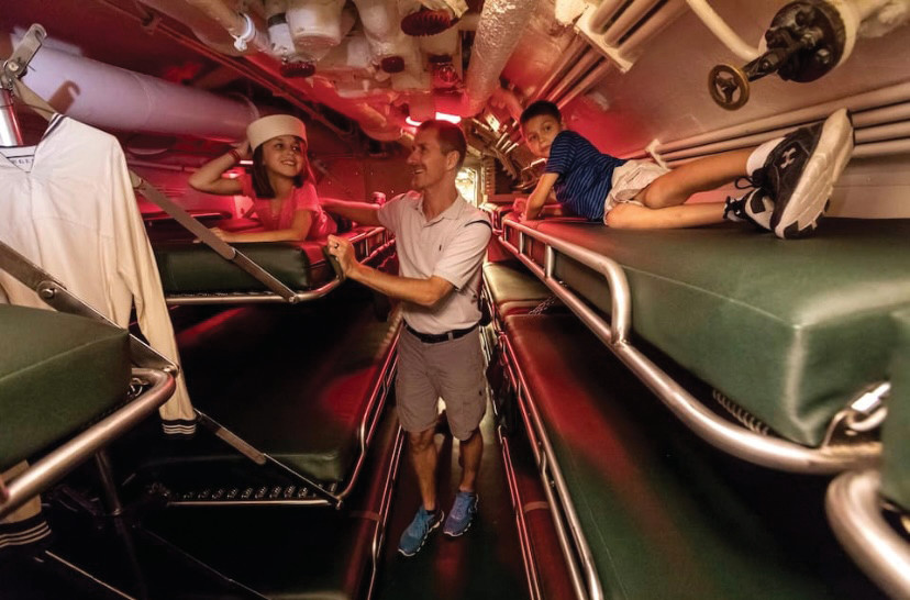 Vacationers rest on cots in an WWII-era submarine at the Sub BnB in Manitowoc, Wisconsin