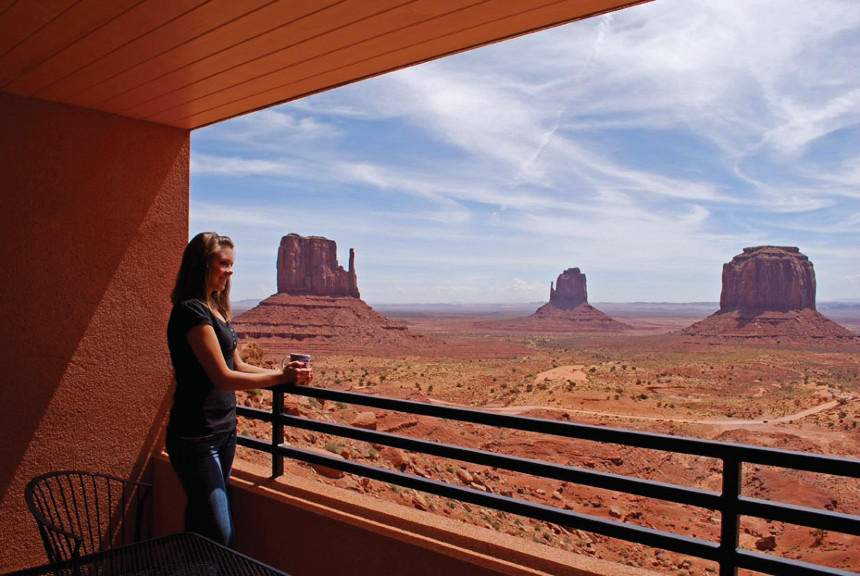 Woman looks out over a balcony at The View Hotel in Monument Valley, Utah