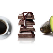 A cup of coffee, a pile of chocolate, and a half of an avocado
