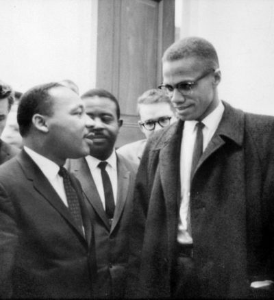 Dr. Martin Luther King speaks with Malcolm X.