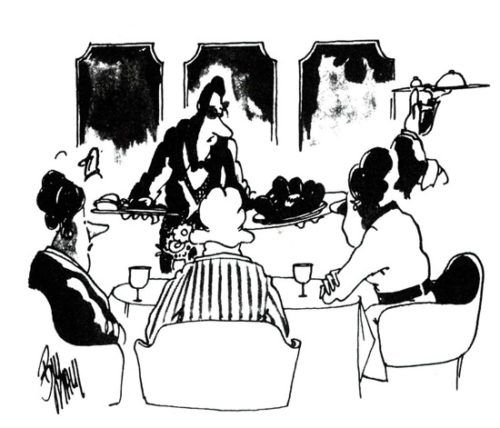 Restaurant patrons sit at a dinner table. The waiter presents a plate with a ball in a catcher's mitt.