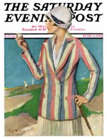 A woman golfer in a sandtrap inspecting a ball.