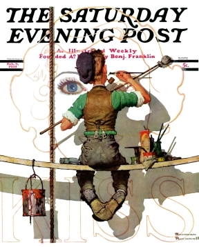 Young man painting billboard