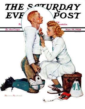 Cheerleader sewing letter onto footballers sweater