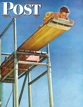 Scared boy looks down from high diving board