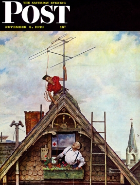 Man mounting TV antenna on rooftop