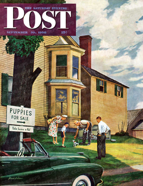 Family picking out puppy in yard of home