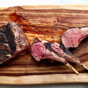 Cuts of barbecue lamb on a wooden cutting board