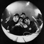 At Miami Beach press conference, John Lennon, Ringo Starr, Paul McCartney, George Harrison bug a fisheye camera. "Yeah! Yeah! Yeah! Music's Gold Bugs: The Beatles," The Saturday Evening Post. March 21, 1964.