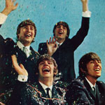 In their new movie, <em>A Hard Day's Night</em>, the Beatles enact a typical triumphal welcome. John and Paul stand behind Ringo and George.