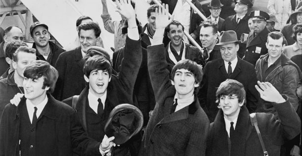 The Beatles wave to fans after arriving at Kennedy Airport on February 7, 1964. Source: United Press International, photographer unknown