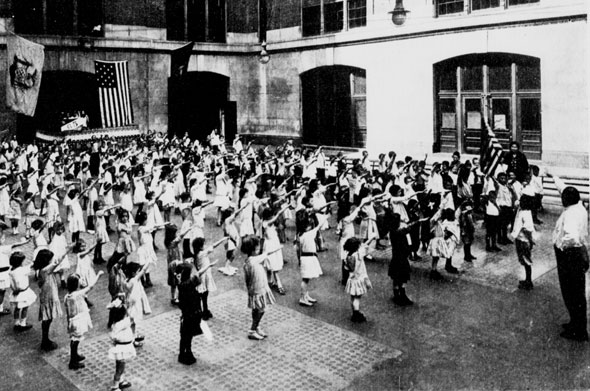 The Youth's Companion included a choreographed flag salute, sometimes called the Bellamy salute. Students were to extend their right hands, palms downward in a military salute, then upturn their palm toward the flag when speaking the words "to my flag" where it would remain for the remainder of the Pledge of Allegiance. During WWII, the salute was abandoned because it closely resembled the Nazi salute. (Photo: New York Tribune, September 12, 1915/Wikimedia Commons)