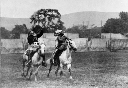 Buffalo Bill demonstrating his sharpshooting skills while riding, 1907.