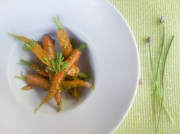 bowl of carrots with carrot top pesto