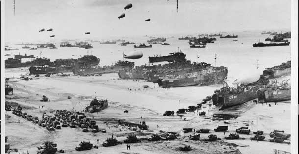 Landing craft, barrage balloons, and troops coming ashore at Normandy on D-Day, June 6, 1944. Source: Library of Congress