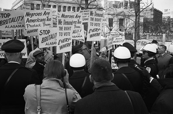 African American demonstrators outside the White House, with signs "We demand the right to vote, everywhere" and signs protesting police brutality against civil rights demonstrators in Selma, Alabama. (Image courtesy of the Library of Congress)