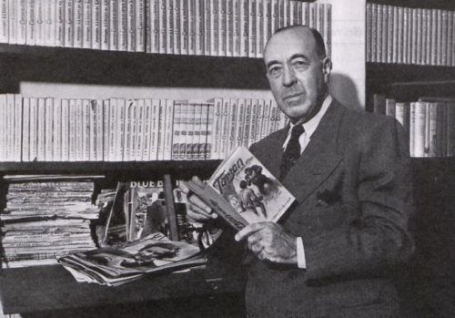 Edgar Rice Burroughs holding copies of Tarzan books
